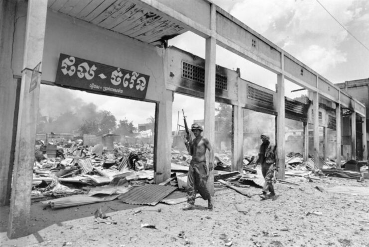 Two soldiers walking through a destroyed shopping center